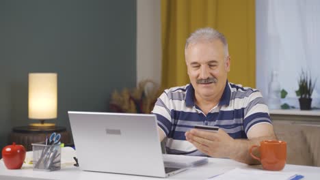Home-office-worker-old-man-doing-online-shopping.